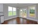 Cozy breakfast nook features hardwood floors, natural light, and access to the back deck at 5491 Silk Hope Gum Springs Rd, Siler City, NC 27344