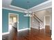 Elegant dining room with coffered ceiling, hardwood floors, and staircase at 5491 Silk Hope Gum Springs Rd, Siler City, NC 27344