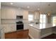 Bright kitchen features stainless steel appliances, granite countertops, and hardwood flooring at 5491 Silk Hope Gum Springs Rd, Siler City, NC 27344