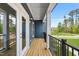 Outdoor balcony featuring wood flooring, dark blue siding, and black metal railing at 555 Forestville Rd, Wake Forest, NC 27587