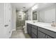 Modern bathroom with double vanity, gray cabinets, and a glass-enclosed shower at 555 Forestville Rd, Wake Forest, NC 27587