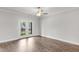 This modern bedroom is bright and spacious with hardwood floors and double doors to a deck or patio at 555 Forestville Rd, Wake Forest, NC 27587