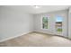 Bright, carpeted bedroom with a door leading to a private balcony at 555 Forestville Rd, Wake Forest, NC 27587