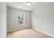 Empty bedroom featuring neutral walls, carpet, and a window with a view of the neighborhood at 555 Forestville Rd, Wake Forest, NC 27587