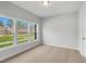 Bright bedroom featuring neutral carpet and three windows offering a great view at 555 Forestville Rd, Wake Forest, NC 27587