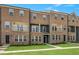 Modern brick townhome with multiple stories, balconies, and manicured landscaping at 555 Forestville Rd, Wake Forest, NC 27587