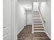 Hallway with hardwood flooring, staircase, and white trim at 555 Forestville Rd, Wake Forest, NC 27587