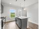 Charming kitchen featuring a kitchen island, stainless steel appliances, and views of the backyard at 555 Forestville Rd, Wake Forest, NC 27587