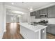 Elegant kitchen featuring an island, stainless steel appliances, and open access to a dining and living area at 555 Forestville Rd, Wake Forest, NC 27587
