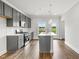 Modern kitchen with stainless steel appliances, white countertops, and a center island with a sink at 555 Forestville Rd, Wake Forest, NC 27587