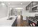 Open-concept kitchen with stainless steel appliances, white countertops, and a view into the living room at 555 Forestville Rd, Wake Forest, NC 27587