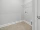 A well-lit laundry room features tiled floors, a wire rack shelf, and utility hookups at 555 Forestville Rd, Wake Forest, NC 27587