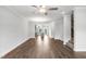 Spacious living area with hardwood floors and view of open kitchen and staircase at 555 Forestville Rd, Wake Forest, NC 27587