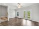 This open-concept living area features hardwood floors, stairs, ceiling fan, and glass patio doors at 555 Forestville Rd, Wake Forest, NC 27587