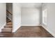 Bright living room with hardwood floors, white trim, and a staircase leading to the second floor at 555 Forestville Rd, Wake Forest, NC 27587