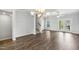Open-concept space with hardwood floors, modern lighting, and stairs leading to the upper level at 555 Forestville Rd, Wake Forest, NC 27587