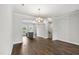 View of open-concept design with hardwood floors and pendant lighting above the kitchen island at 555 Forestville Rd, Wake Forest, NC 27587