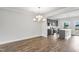 Spacious living area with hardwood floors, gray cabinets, modern appliances, and ample natural light at 555 Forestville Rd, Wake Forest, NC 27587