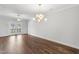 This spacious living room has hardwood floors, a ceiling fan, and double doors leading to the outside at 555 Forestville Rd, Wake Forest, NC 27587