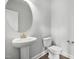 Well-lit powder room featuring a modern sink and toilet at 555 Forestville Rd, Wake Forest, NC 27587