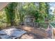 Spacious back deck featuring a small gazebo and wooden railing with mature trees at 612 Locust Ln, Raleigh, NC 27603