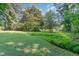 Large backyard with mature trees provides a serene and private outdoor setting at 612 Locust Ln, Raleigh, NC 27603