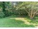 Picturesque backyard featuring mature trees creating a tranquil and shaded retreat at 612 Locust Ln, Raleigh, NC 27603