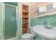 Compact bathroom with a shower stall, toilet, and vanity with storage shelves at 612 Locust Ln, Raleigh, NC 27603
