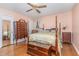 Bedroom with hardwood floors, a four-poster bed, and a chest of drawers at 612 Locust Ln, Raleigh, NC 27603
