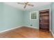 Bedroom with hardwood floors, a window, and a wooden bookshelf at 612 Locust Ln, Raleigh, NC 27603