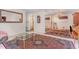 Open-concept dining space featuring a grand mirror, classic chandelier, and a large patterned rug at 612 Locust Ln, Raleigh, NC 27603