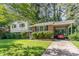 A well-maintained home boasts a brick facade, traditional shutters, and a cozy covered carport at 612 Locust Ln, Raleigh, NC 27603