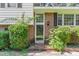 Close-up of front entrance showcasing brick details and lush greenery enhancing the welcoming entryway at 612 Locust Ln, Raleigh, NC 27603