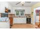 Functional kitchen with white cabinetry, black appliances, and a double basin sink under a window at 612 Locust Ln, Raleigh, NC 27603