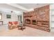 Cozy living room with a brick fireplace, built-in shelving, and carpeted flooring at 612 Locust Ln, Raleigh, NC 27603