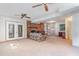 Spacious living room featuring a large brick fireplace and built-in shelving for storage at 612 Locust Ln, Raleigh, NC 27603