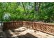 Outdoor wooden deck with a lattice railing and surrounding green trees and landscaping at 616 Cross Timbers Dr, Durham, NC 27713