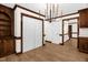 Traditional dining area features wood floors and trim, white walls, and modern chandelier at 616 Cross Timbers Dr, Durham, NC 27713