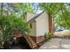 Two story home featuring a wooden deck, brick chimney, and vinyl siding, surrounded by trees at 616 Cross Timbers Dr, Durham, NC 27713