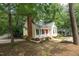Home exterior featuring a brick chimney, front porch, and well-maintained lawn at 616 Cross Timbers Dr, Durham, NC 27713