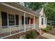 Inviting front porch with white railings and a vibrant red door, enhancing the home's curb appeal at 616 Cross Timbers Dr, Durham, NC 27713