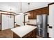 Bright kitchen featuring a center island, wood cabinets, stainless steel appliances, and ample storage at 616 Cross Timbers Dr, Durham, NC 27713