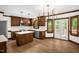 Well-lit kitchen featuring a central island, wood cabinets, and doors leading to a deck at 616 Cross Timbers Dr, Durham, NC 27713