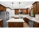 Modern kitchen with stainless steel appliances, wood cabinets, and a large center island at 616 Cross Timbers Dr, Durham, NC 27713