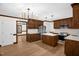 Spacious kitchen with wooden cabinets, stainless steel appliances, and stylish pendant lighting at 616 Cross Timbers Dr, Durham, NC 27713