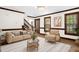 A cozy living room with hardwood floors, neutral decor, and abundant natural light at 616 Cross Timbers Dr, Durham, NC 27713