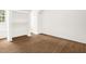 Neutral room featuring updated hardwood floors, white walls, and closet space at 616 Cross Timbers Dr, Durham, NC 27713