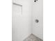 Shower showcasing white vertical tiling, a built-in niche, and decorative flooring at 616 Cross Timbers Dr, Durham, NC 27713