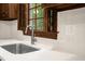 Close-up of a kitchen sink with a stainless steel faucet and a window with shutters at 616 Cross Timbers Dr, Durham, NC 27713