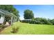 View of expansive backyard with storage shed, mature trees and green grass at 6600 Sadie Dr, Wendell, NC 27591